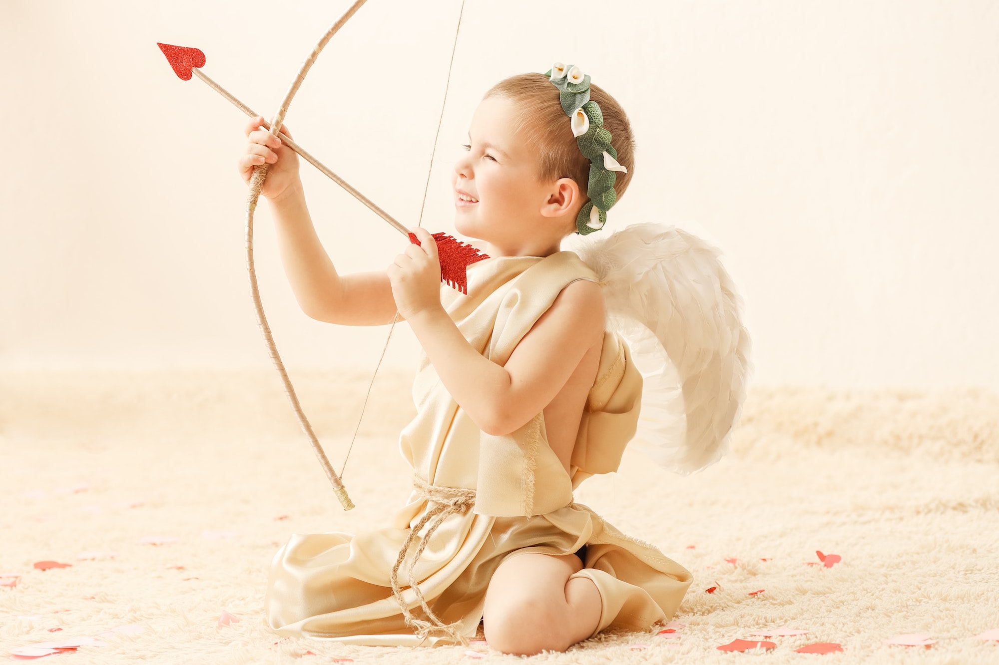 A little boy in a cupid costume